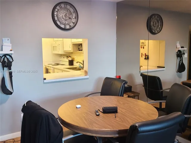 a view of a dining room with furniture and a large window