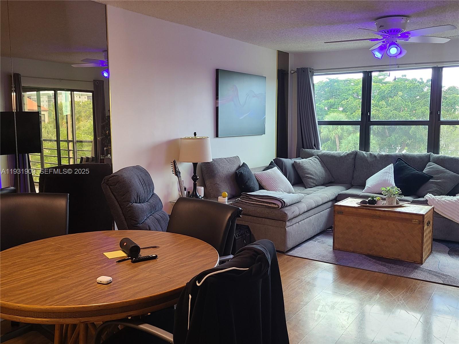 2306 South Cypress Bend Drive, Unit 418 Pompano Beach, FL 33069 - Photo 14 of 18 a living room with furniture and a window