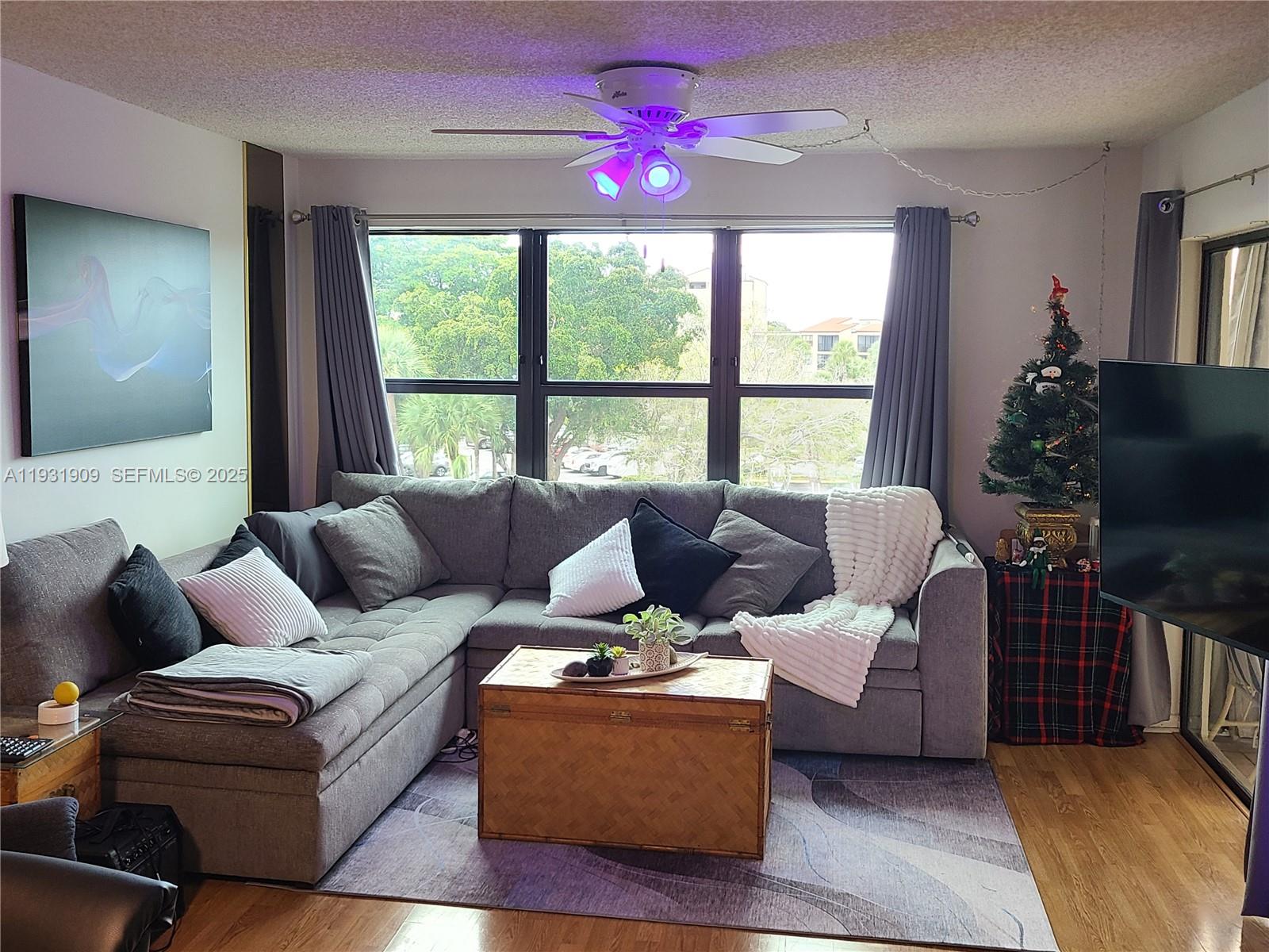 2306 South Cypress Bend Drive, Unit 418 Pompano Beach, FL 33069 - Photo 18 of 18 a living room with furniture and a flat screen tv