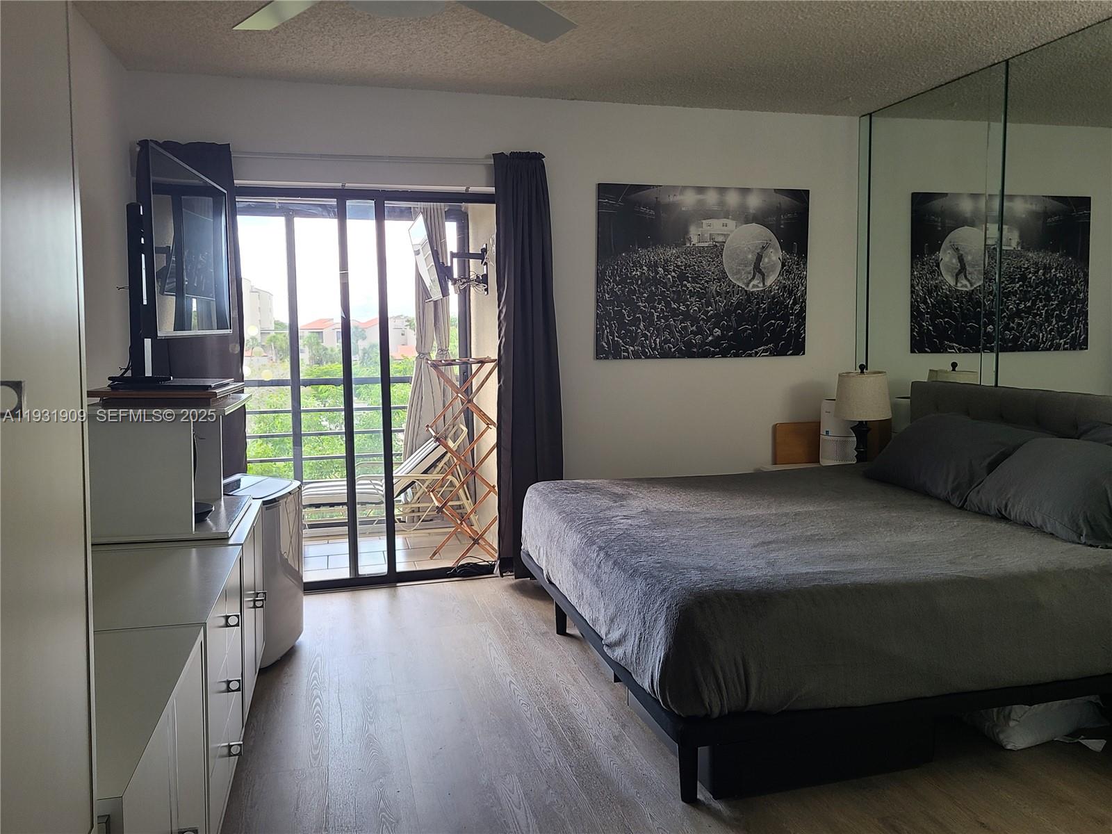 2306 South Cypress Bend Drive, Unit 418 Pompano Beach, FL 33069 - Photo 4 of 18 a bedroom with a large bed and a window