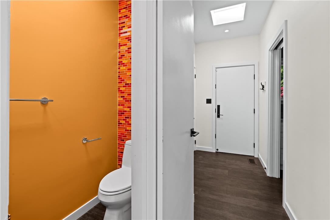 1506 Pleasant View Road Coopersburg, PA 18036 - Photo 63 of 97 A well-lit, contemporary powder room showcases a vibrant accent wall and rich flooring.