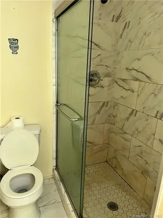 a bathroom with a toilet and a shower