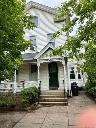 a front view of a house with a garden