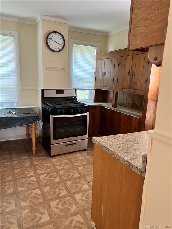 259 Humphrey Street, Unit 2 New Haven, CT 06511 - Photo 2 of 13 a kitchen with granite countertop a stove top oven cabinets and a refrigerator