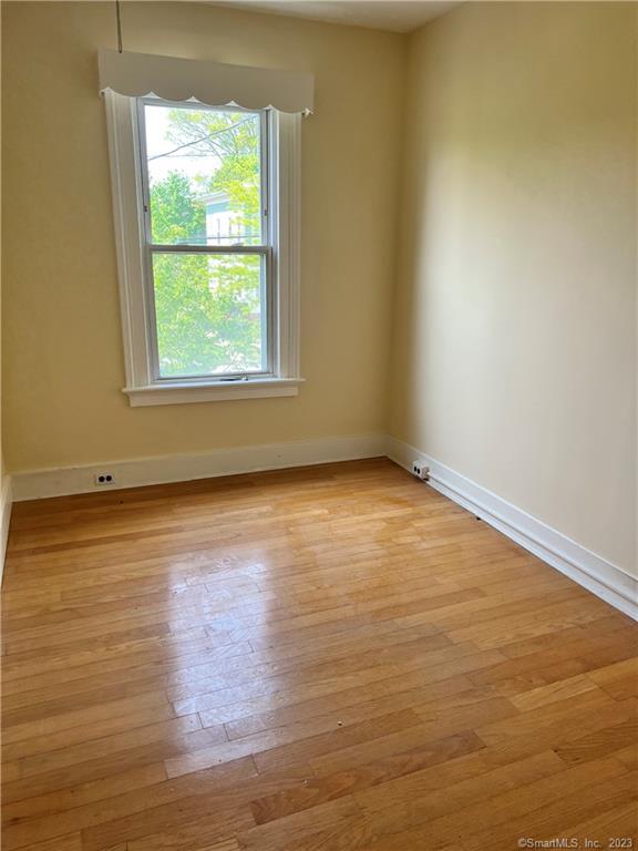 259 Humphrey Street, Unit 2 New Haven, CT 06511 - Photo 5 of 13 an empty room with wooden floor and windows