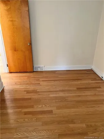 a view of room with wooden floor