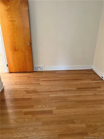 a view of room with wooden floor