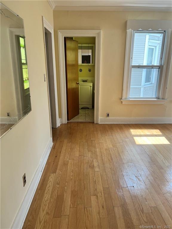 259 Humphrey Street, Unit 2 New Haven, CT 06511 - Photo 10 of 13 a view of a room with wooden floor and a window
