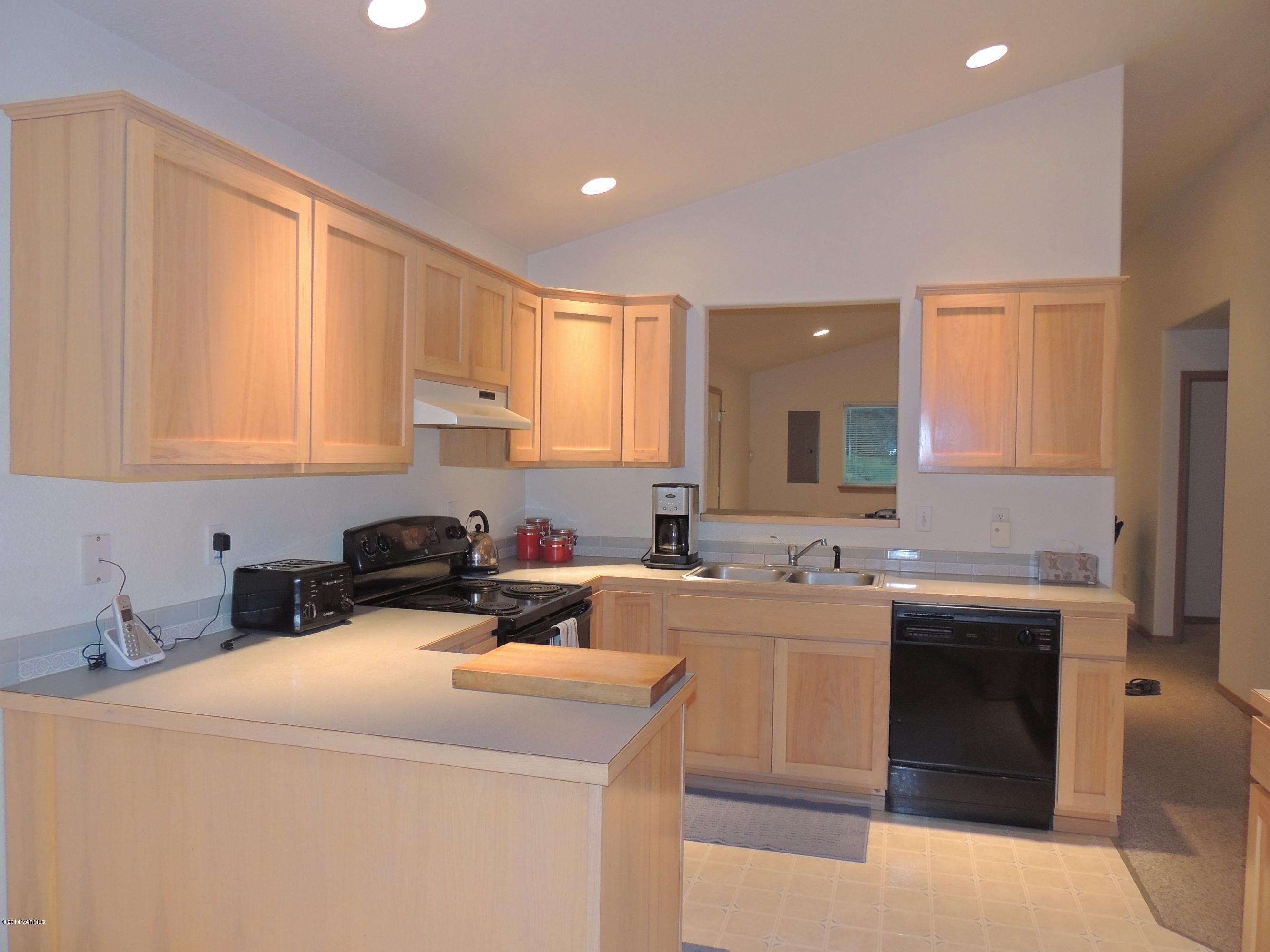 270 Red Tail Road Yakima, WA 98908 - Photo 8 of 69 a kitchen with a sink a stove and cabinets