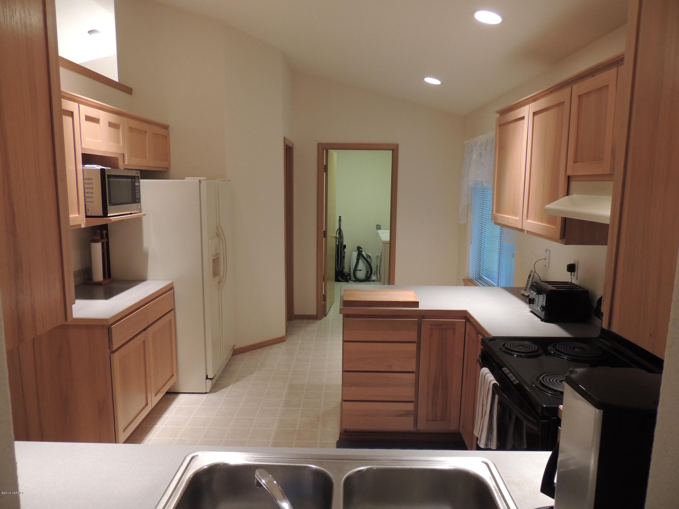 270 Red Tail Road Yakima, WA 98908 - Photo 9 of 69 a kitchen with a refrigerator and a stove top oven