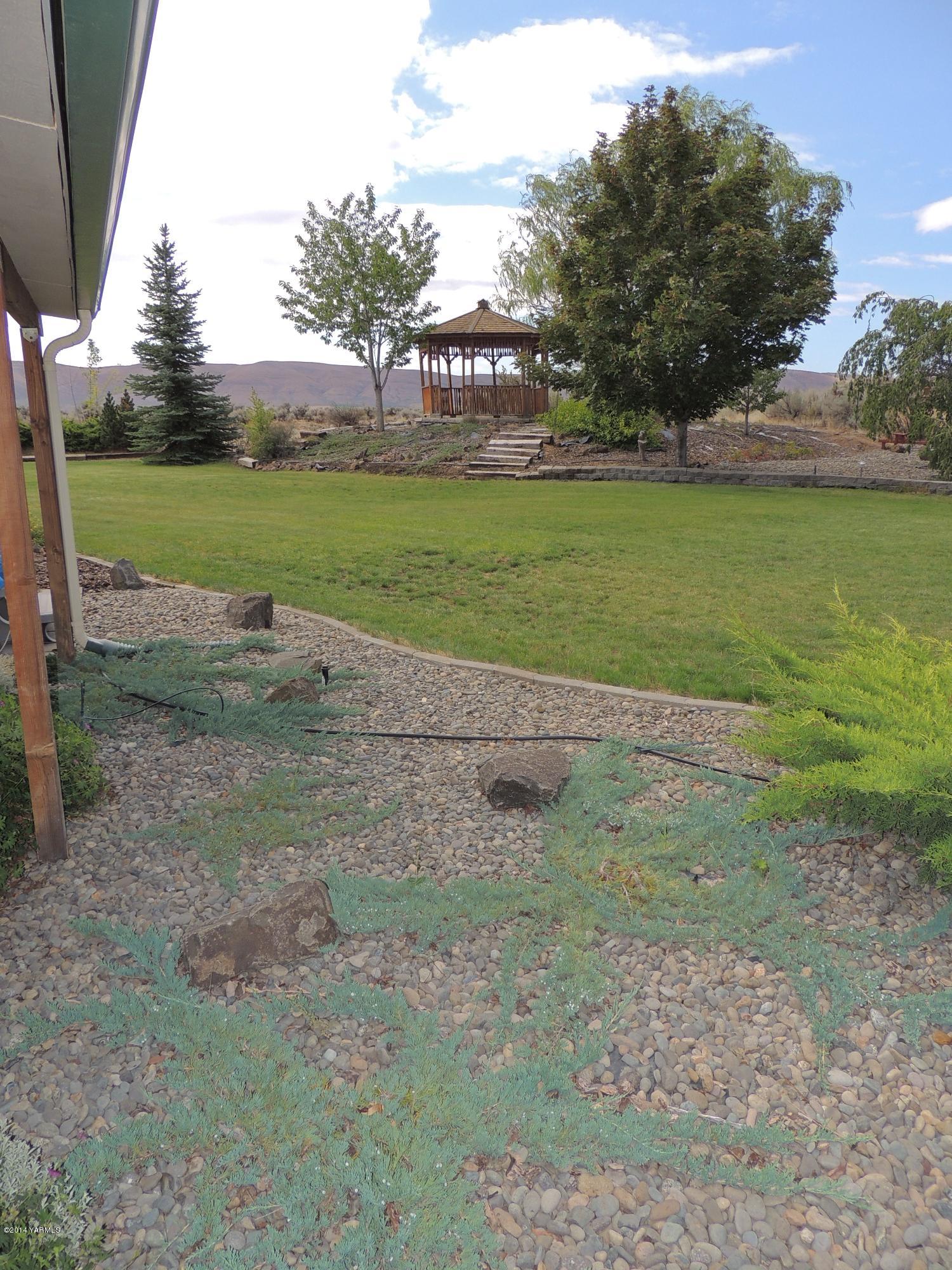 270 Red Tail Road Yakima, WA 98908 - Photo 10 of 69 a view of a field with trees in the background