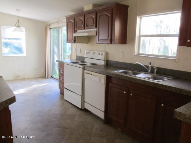 830 Gregory Road Jacksonville, FL 32234 - Photo 8 of 31 KITCHEN & EAT-IN AREA W/SLIDER