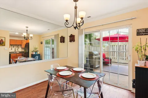 a view of a dining room with furniture wooden floor and chandelier