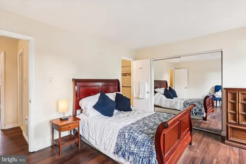 a bed room with bed and a chair