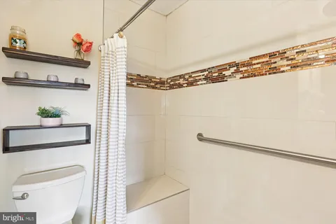 a bathroom with a sink toilet and mirror