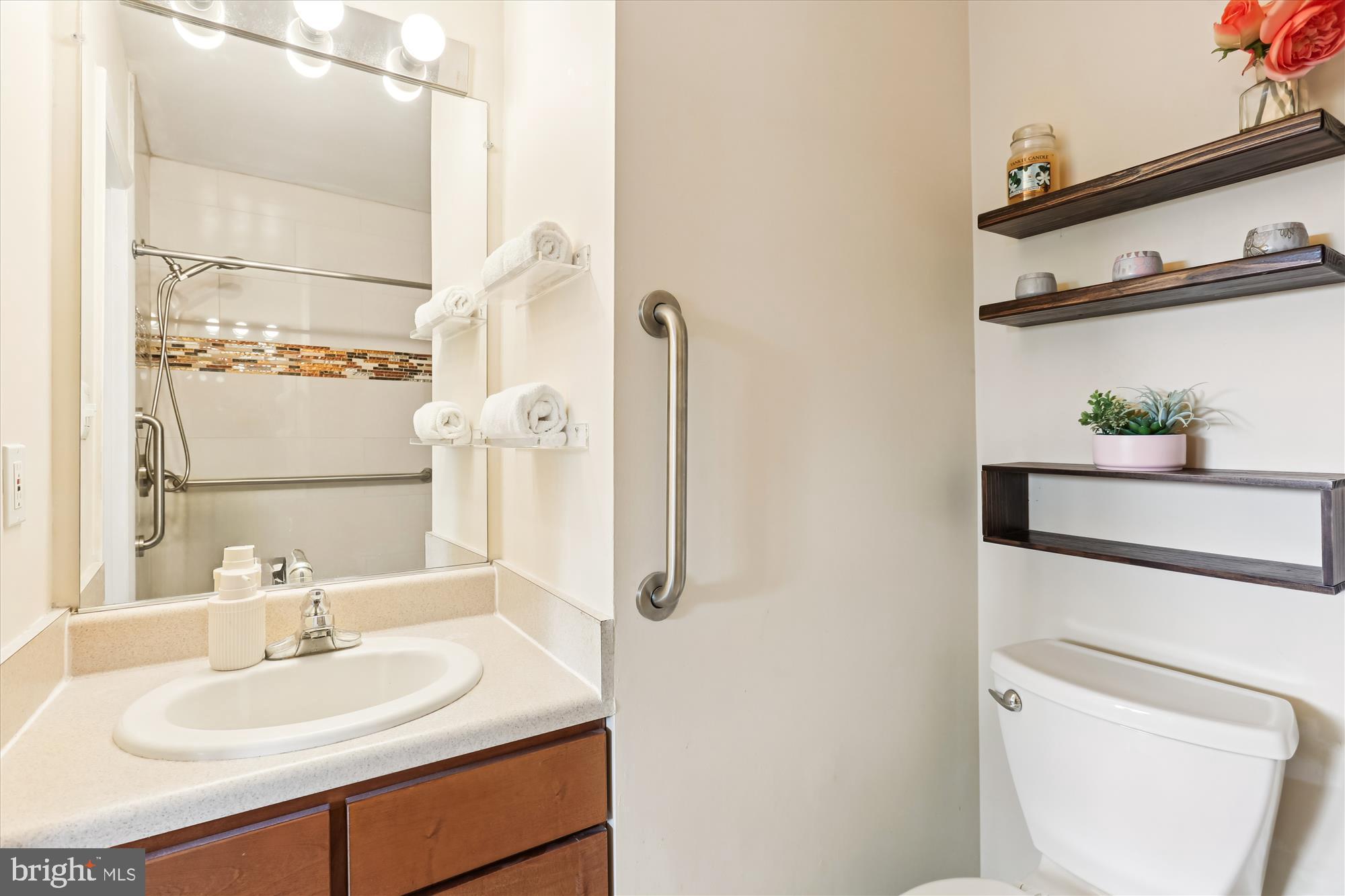 11407 Stoney Point Place Germantown, MD 20876 - Photo 17 of 85 a bathroom with a sink toilet and mirror