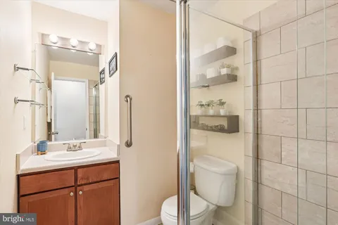 a front view of a house with a small yard and wooden fence