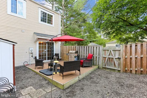a picture of a bench in front of a white house