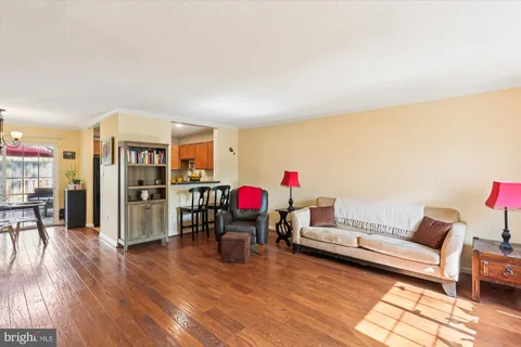 a living room with furniture and kitchen view