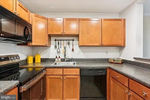 a kitchen with stainless steel appliances granite countertop a sink stove and microwave