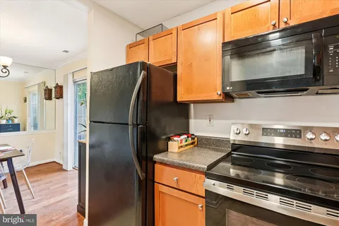 a kitchen with stainless steel appliances a refrigerator stove and microwave