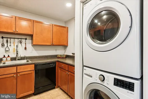 a kitchen with a sink and a washer dryer
