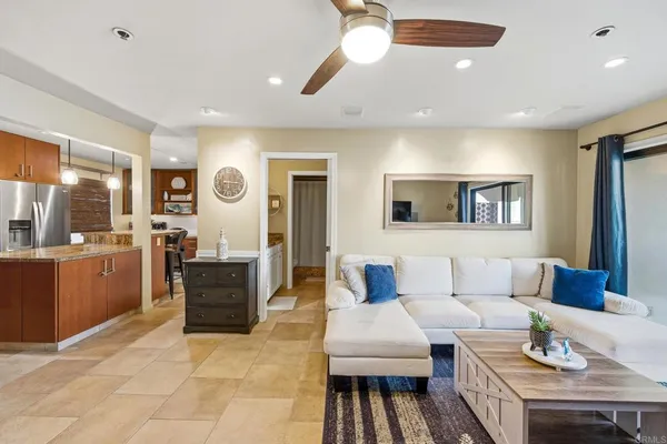 a living room with furniture kitchen and a window