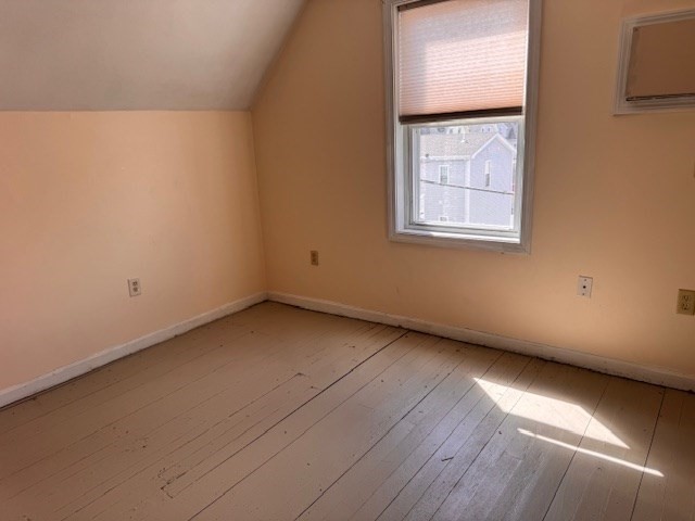 14 Dane Street, Unit 3 Everett, MA 02149 - Photo 3 of 19 an empty room with wooden floor and windows