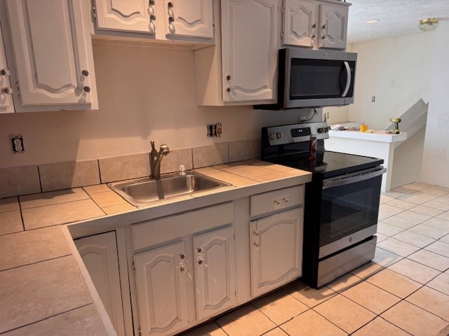 14 Dane Street, Unit 3 Everett, MA 02149 - Photo 6 of 19 a kitchen with stainless steel appliances granite countertop a sink and a microwave