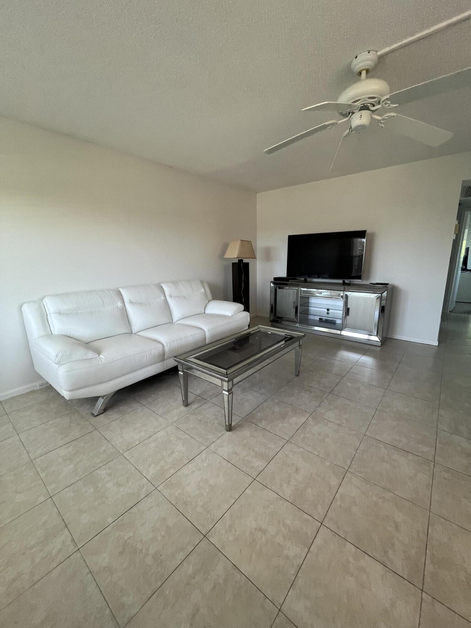 3081 Cornwall East Boca Raton, FL 33434 - Photo 2 of 16 a living room with furniture and a flat screen tv