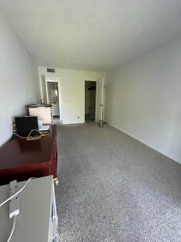 a living room with furniture and a dresser