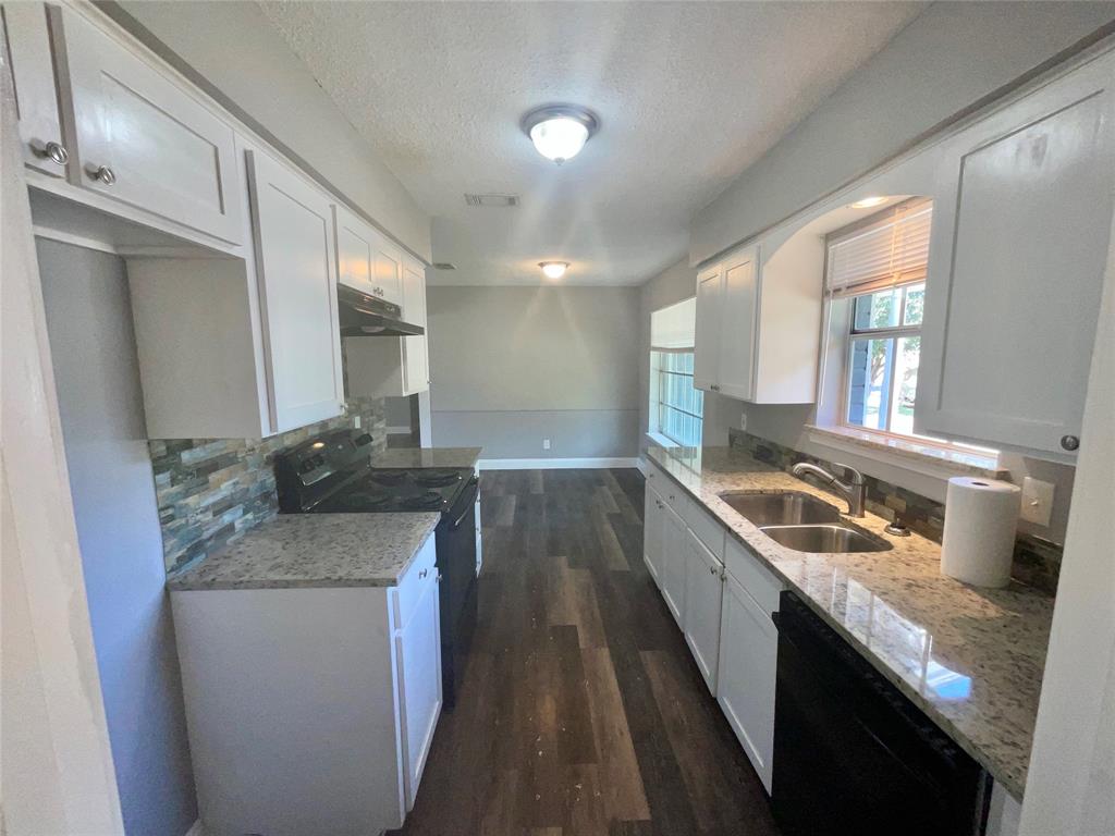 3008 Arapaho Road Commerce, TX 75428 - Photo 3 of 32 Updated Kitchen Featuring Granite Countertops & Luxury Vinyl Plank Flooring