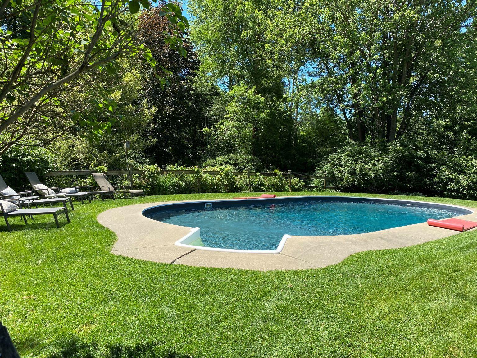 65 Conrad Road New Canaan, CT 06840 - Photo 3 of 12 a view of a swimming pool with a lake