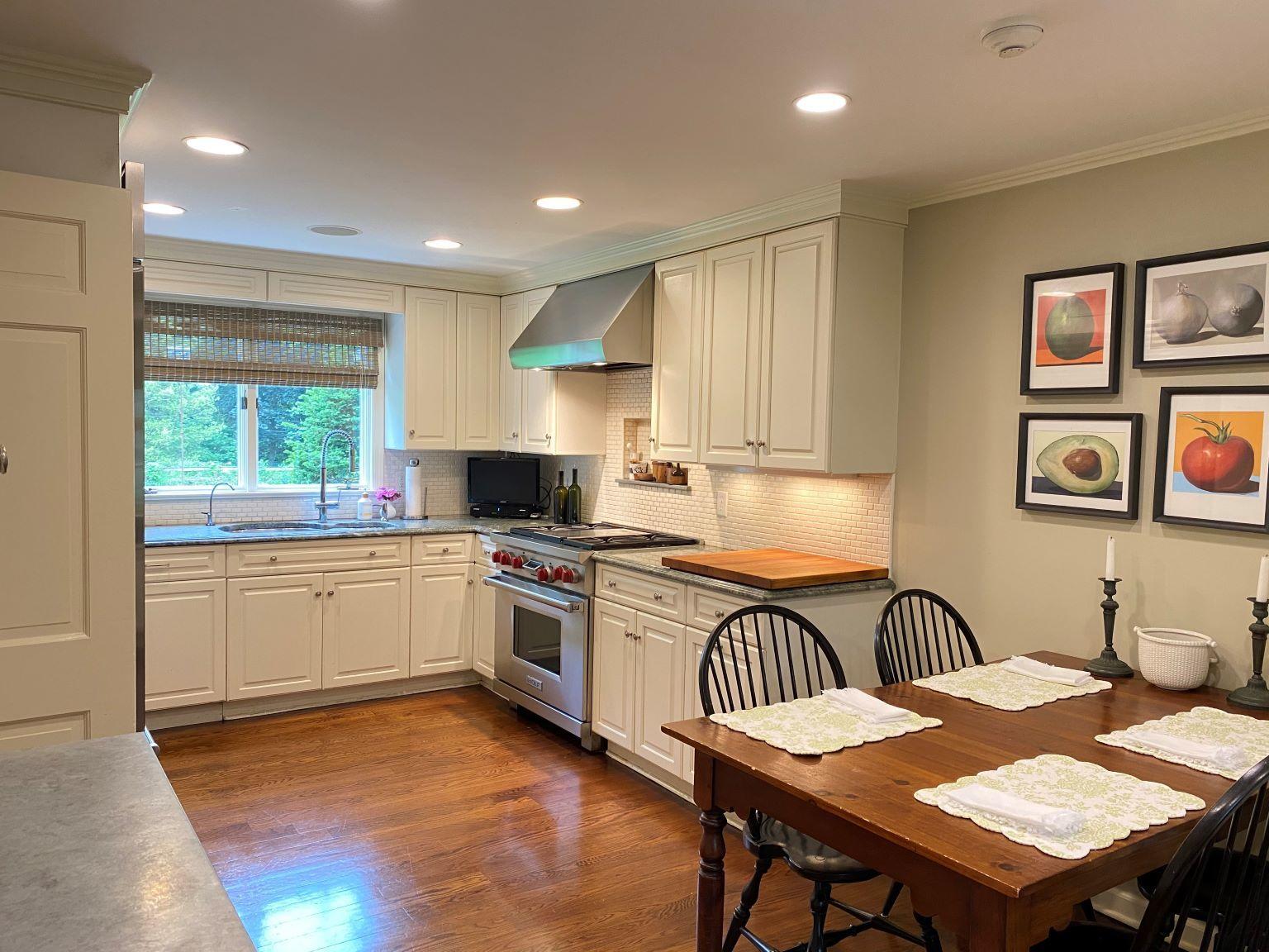 65 Conrad Road New Canaan, CT 06840 - Photo 7 of 12 a kitchen with a table chairs stove and refrigerator