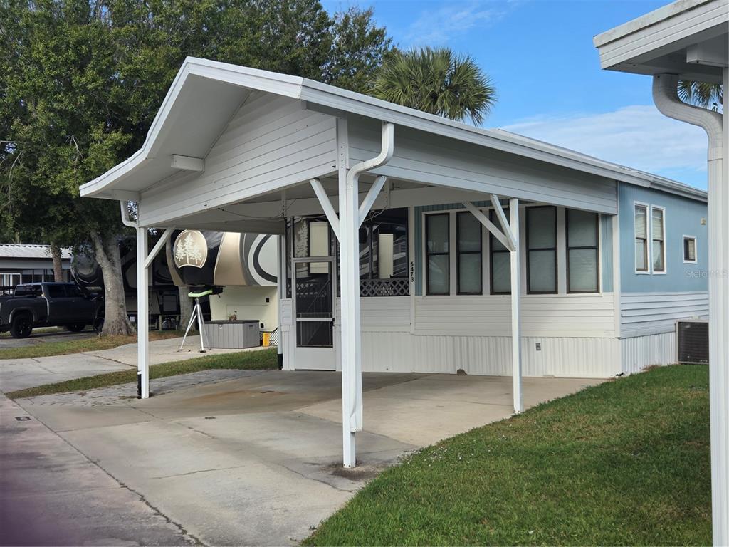 a view of small house with a yard