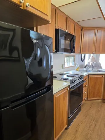 a view of house with entryway and a yard