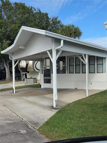a view of a patio with dining table and chairs