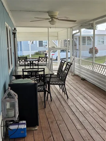 a living room with furniture a flat screen tv and kitchen view