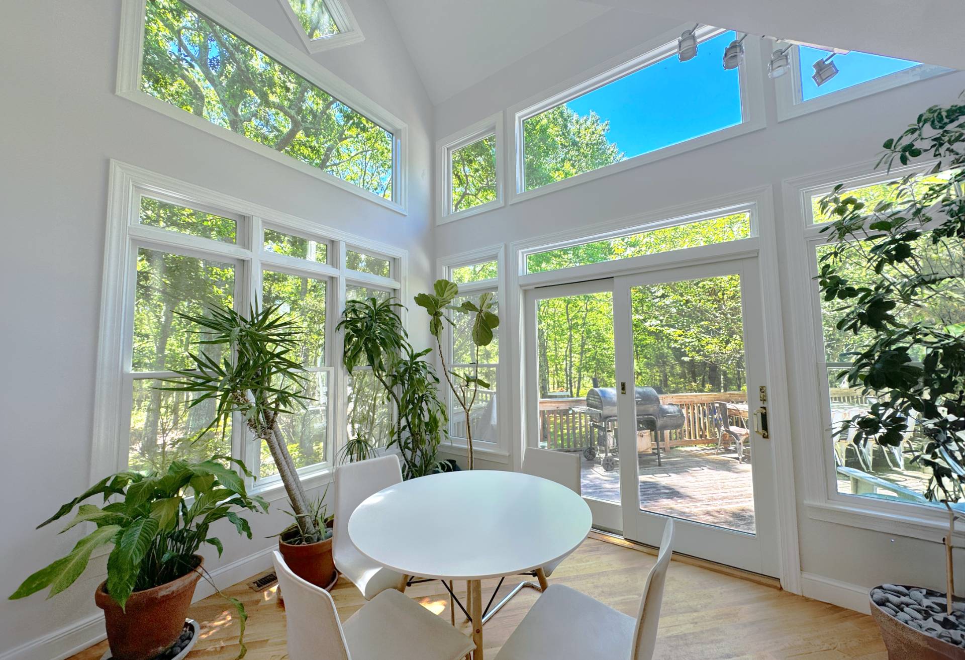 9 Ely Brook Road East Hampton, NY 11937 - Photo 4 of 22 a dining room with furniture potted plants and wooden floor
