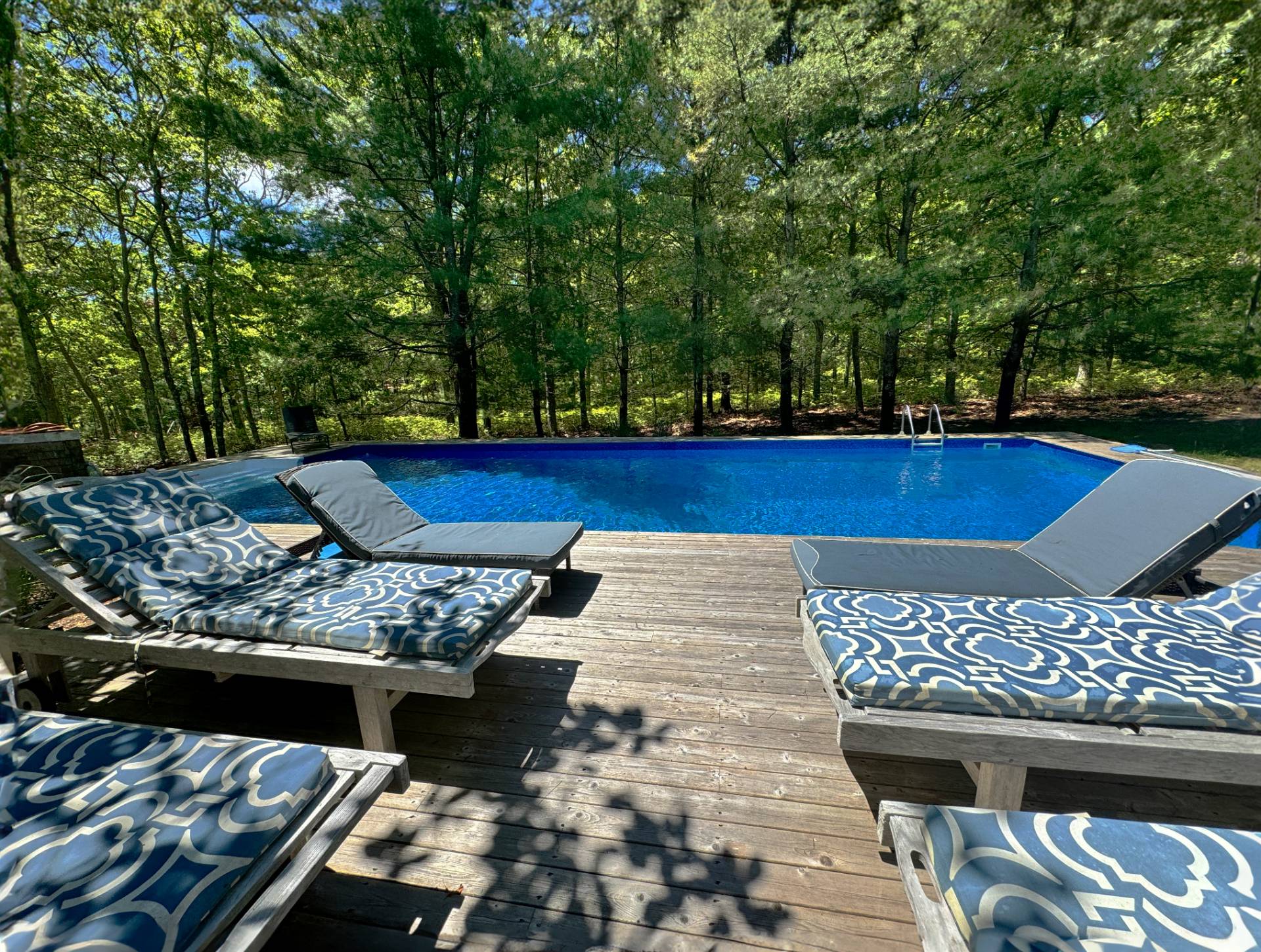 9 Ely Brook Road East Hampton, NY 11937 - Photo 8 of 22 a view of a patio with table and chairs and potted plants