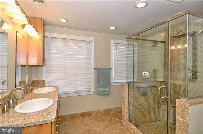 2204 Countryside Drive Silver Spring, MD 20905 - Photo 20 of 29 a bathroom with a granite countertop sink mirror and shower