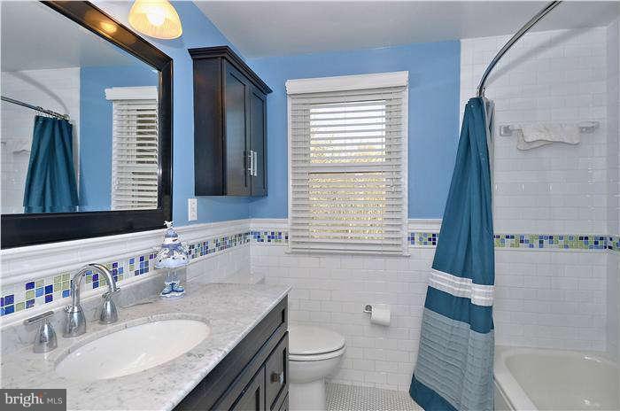 2204 Countryside Drive Silver Spring, MD 20905 - Photo 21 of 29 a bathroom with a granite countertop sink toilet and shower