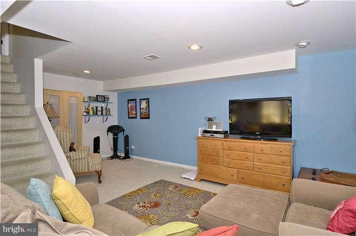 2204 Countryside Drive Silver Spring, MD 20905 - Photo 24 of 29 a living room with furniture and a flat screen tv