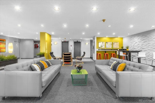 a living room with furniture and kitchen view