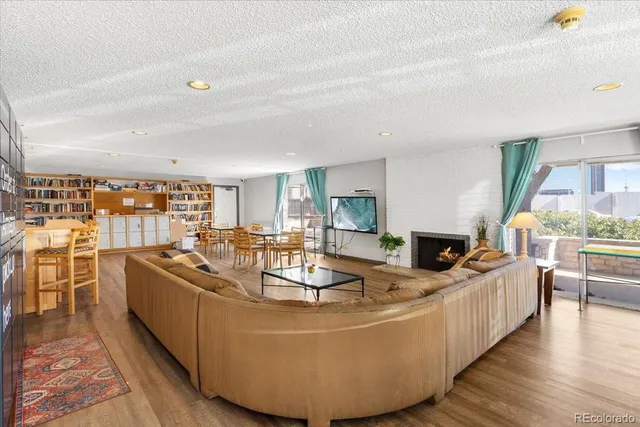 a living room with fireplace furniture and a kitchen counter top