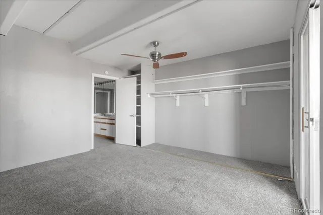 an empty room with closet and windows