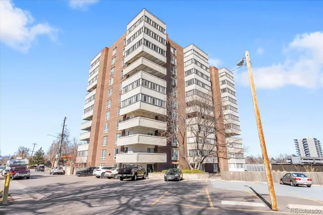 a view of a tall building next to a road