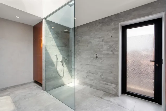 a bathroom with a glass shower door