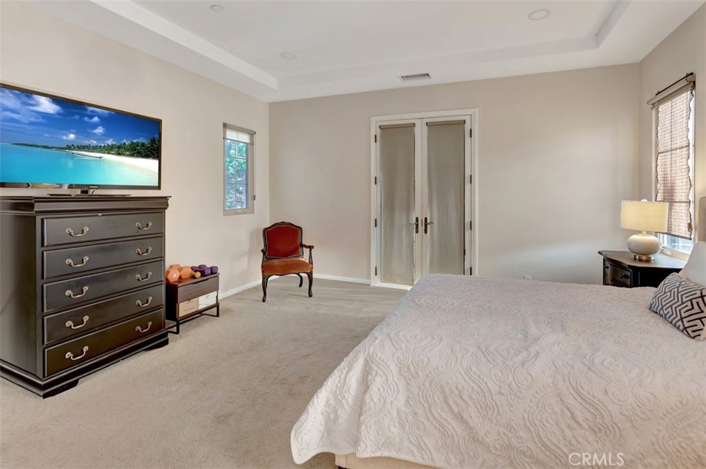 67 Hanging Garden Irvine, CA 92620 - Photo 12 of 23 a bedroom with a bed and a window