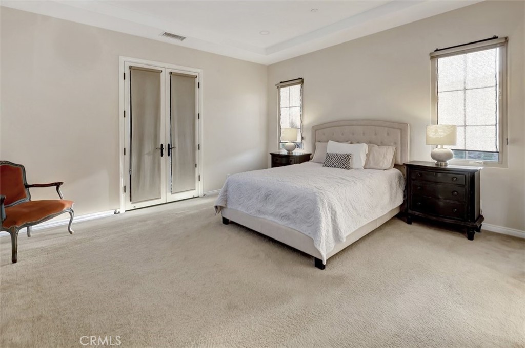 67 Hanging Garden Irvine, CA 92620 - Photo 13 of 23 a bedroom with a bed lamp and a window